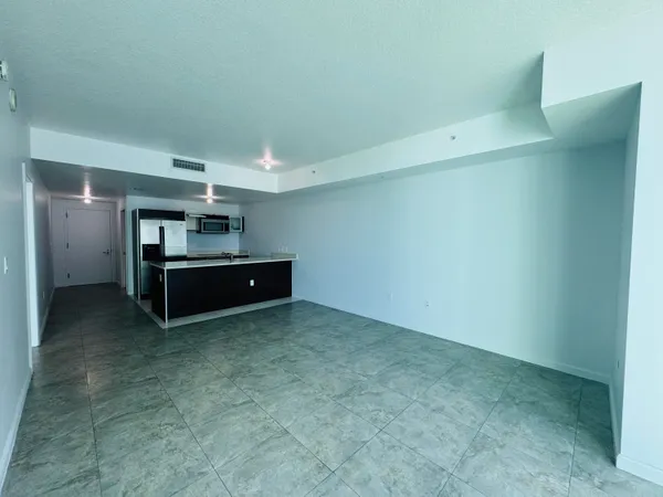 a view of an empty room with cabinet