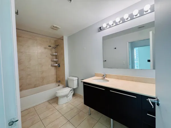 a view of bathroom with a toilet sink and mirror