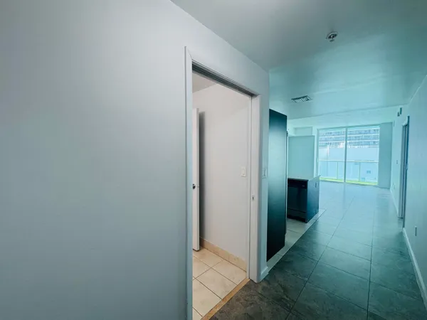 a view of hallway with wooden floor