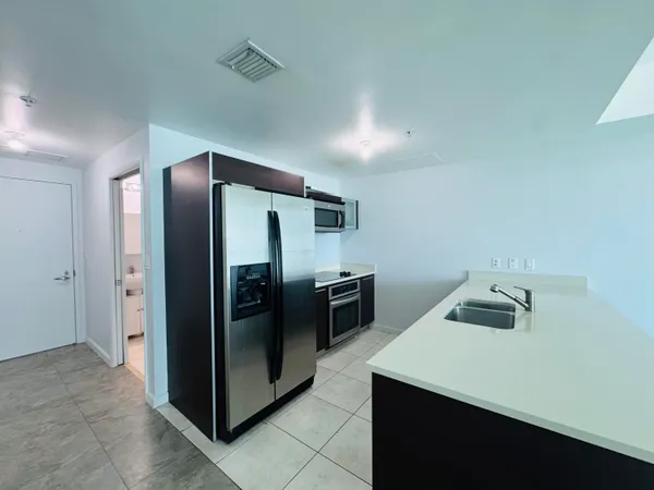 a kitchen with stainless steel appliances a refrigerator and a sink
