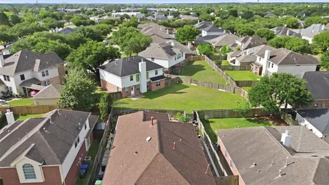 an aerial view of a house with garden space and street view