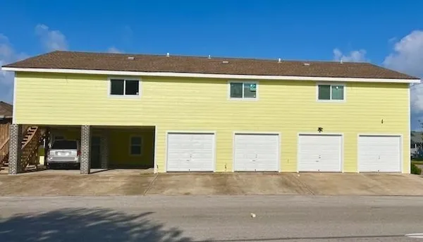 a front view of a house with a parking space