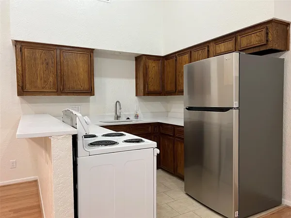 a kitchen with stainless steel appliances a refrigerator and a stove top oven