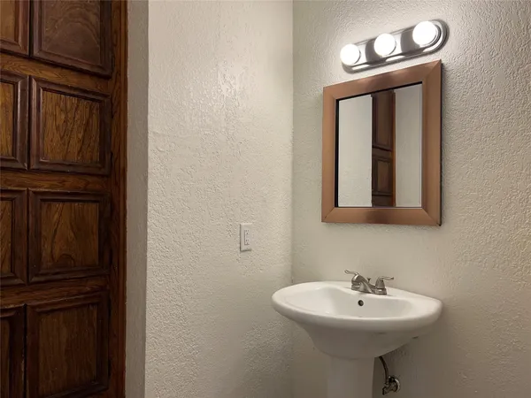 a bathroom with a sink a mirror and vanity