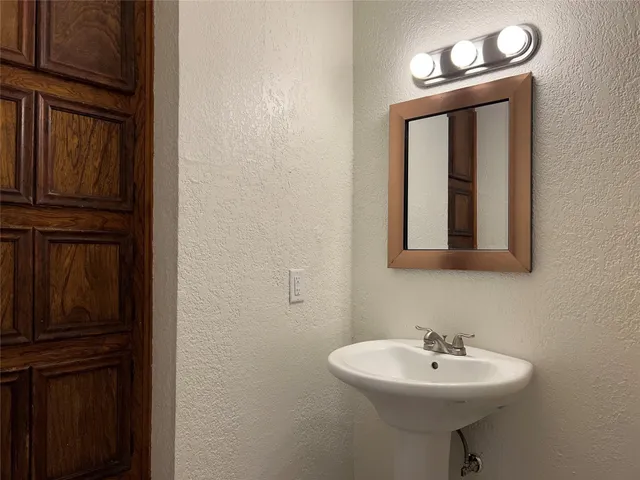 a bathroom with a sink a mirror and vanity