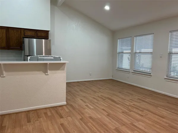 a view of kitchen and wooden floor