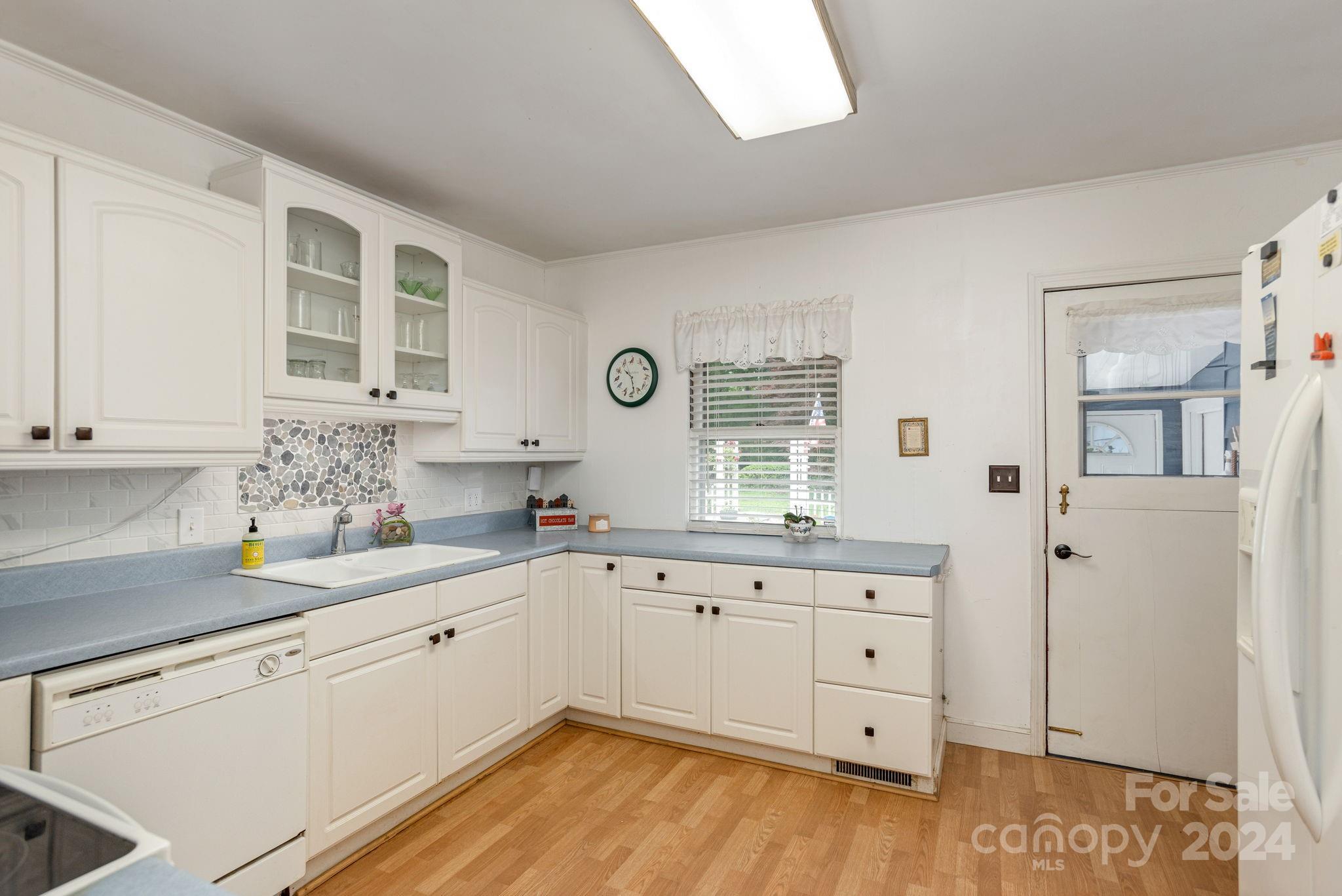 1489 Lynn Road Tryon, NC 28782 - Photo 15 of 46 a kitchen with white cabinets and sink