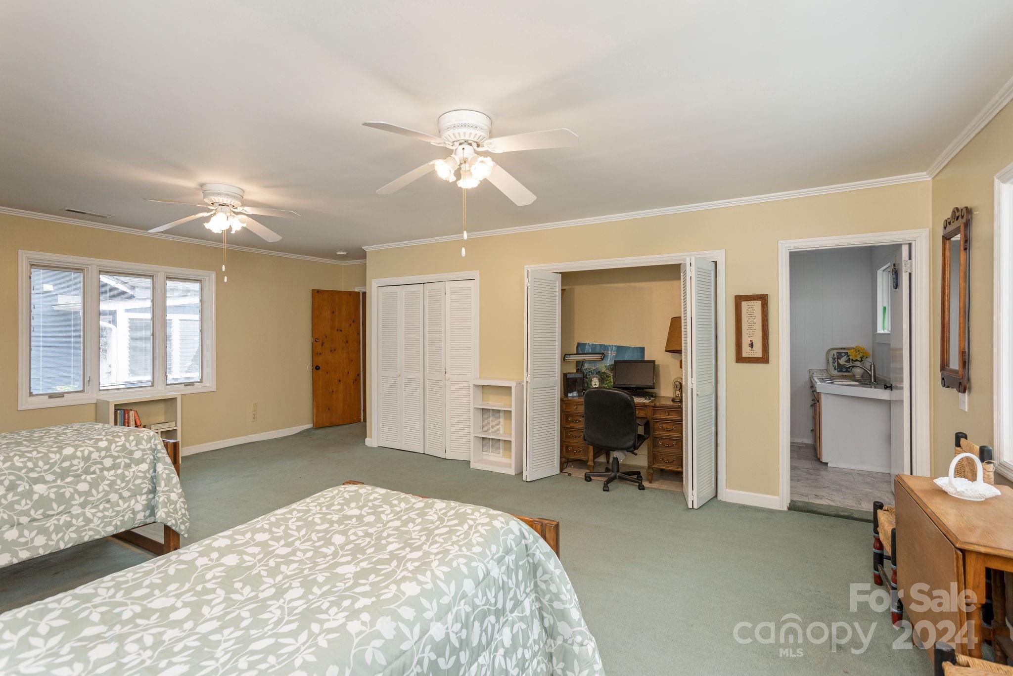 1489 Lynn Road Tryon, NC 28782 - Photo 25 of 46 a bedroom with a bed and a chandelier
