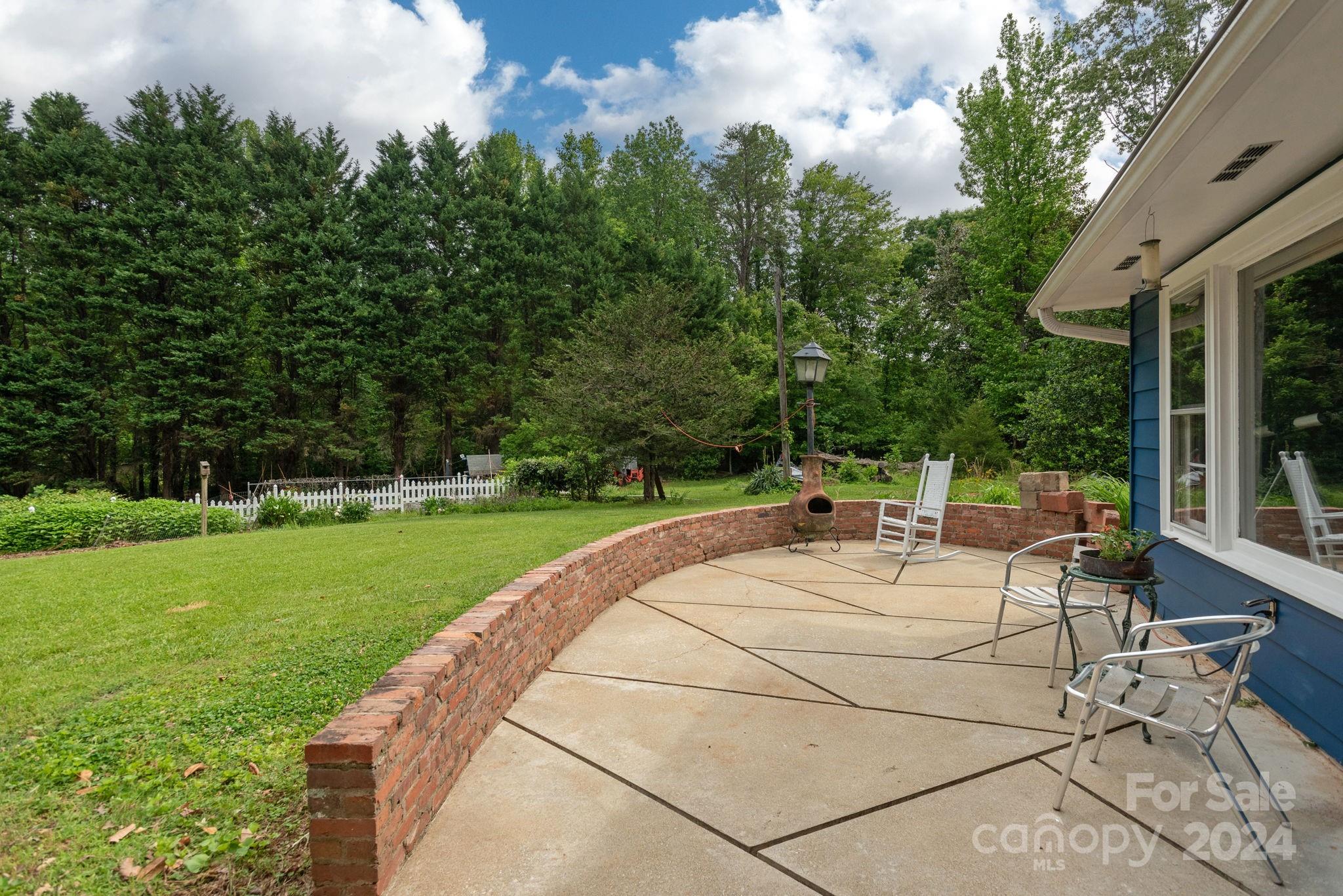 1489 Lynn Road Tryon, NC 28782 - Photo 29 of 46 a view of a patio with a table and chairs