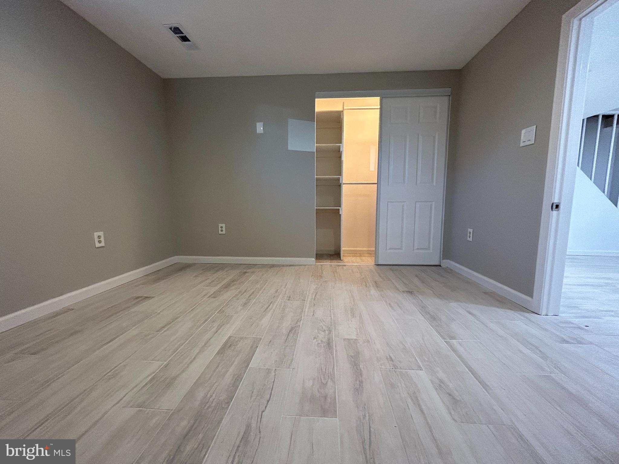 7131 Gormel Drive Springfield, VA 22150 - Photo 12 of 27 wooden floor in an empty room with a window