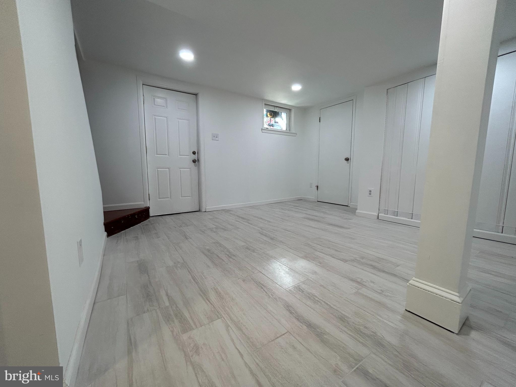 7131 Gormel Drive Springfield, VA 22150 - Photo 17 of 27 an empty room with wooden floor and windows