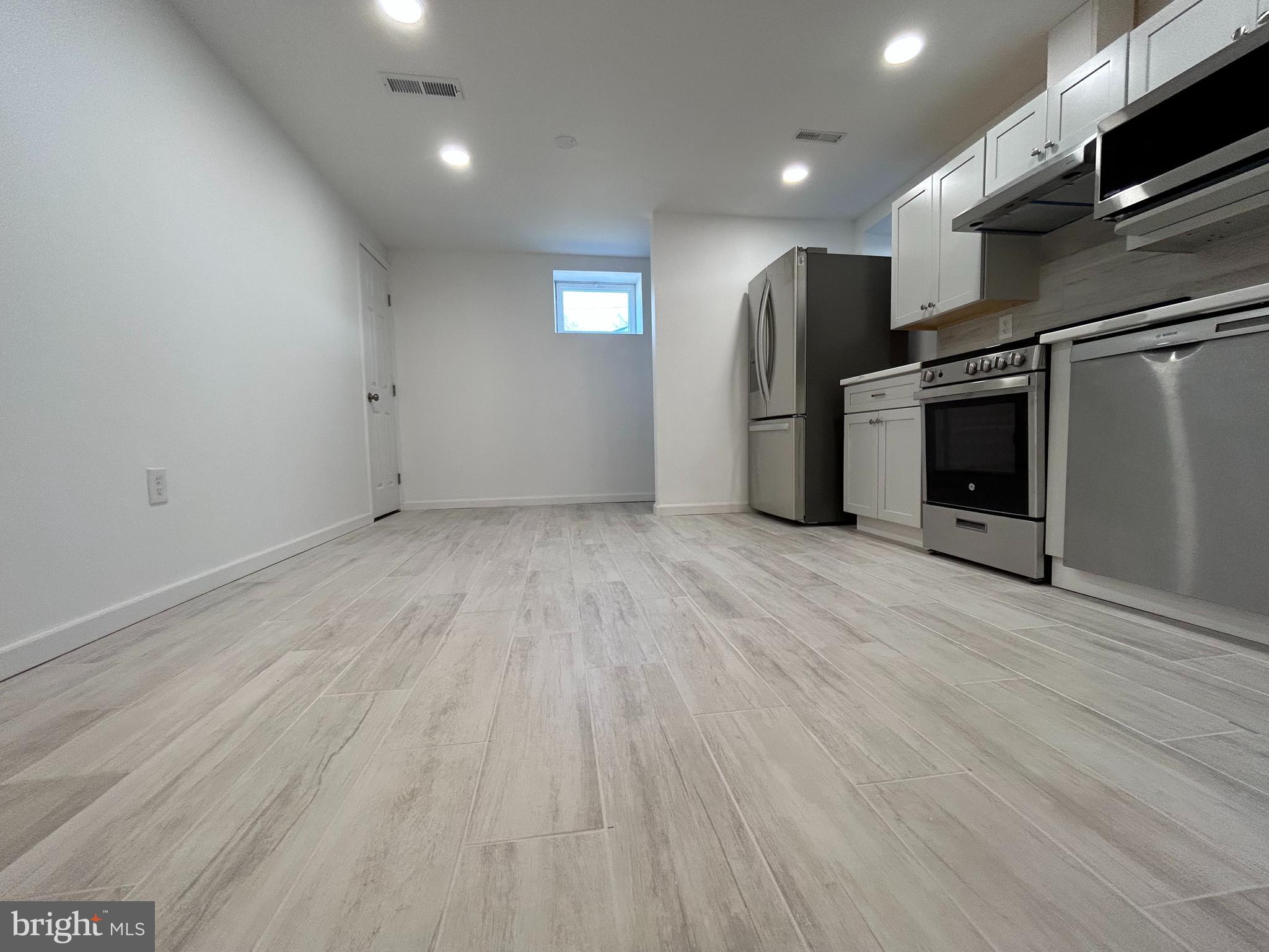 7131 Gormel Drive Springfield, VA 22150 - Photo 5 of 27 a view of a kitchen with a sink and a refrigerator