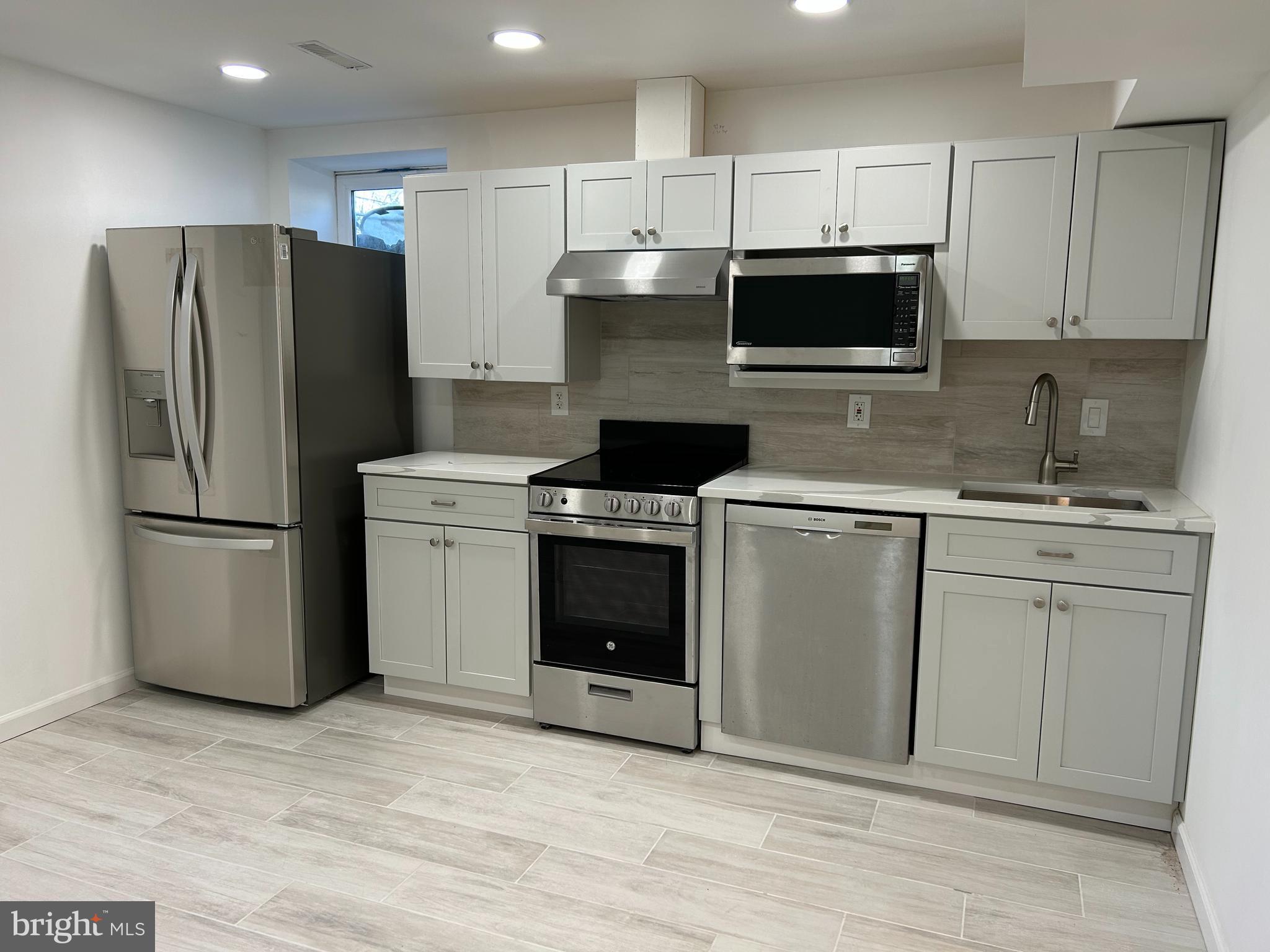 7131 Gormel Drive Springfield, VA 22150 - Photo 6 of 27 a kitchen with cabinets stainless steel appliances and a counter space