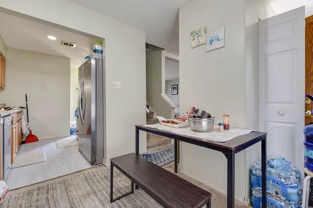 a view of a hallway that has a table and a workspace