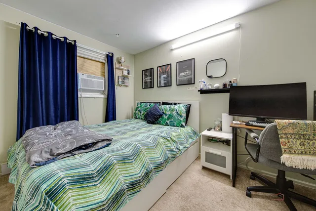 a bedroom with a bed and flat screen tv