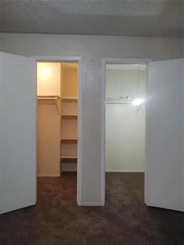 a view of an empty room and a window