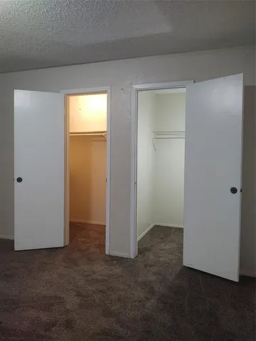 an empty room with closet area