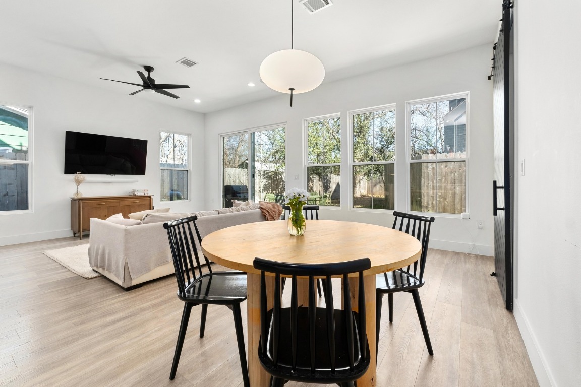 3302 Thompson Street, Unit 1 Austin, TX 78702 - Photo 12 of 32 a view of a dining room with furniture window and wooden floor