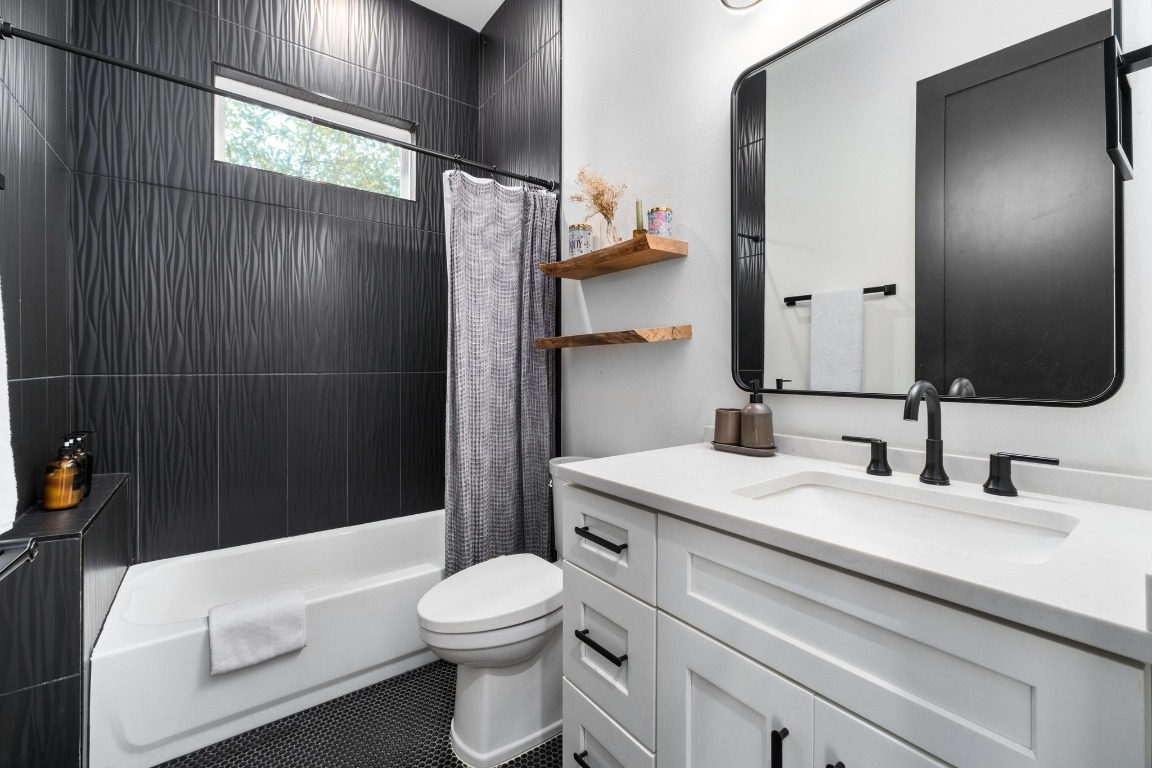 3302 Thompson Street, Unit 1 Austin, TX 78702 - Photo 18 of 32 a bathroom with a sink a toilet and shower