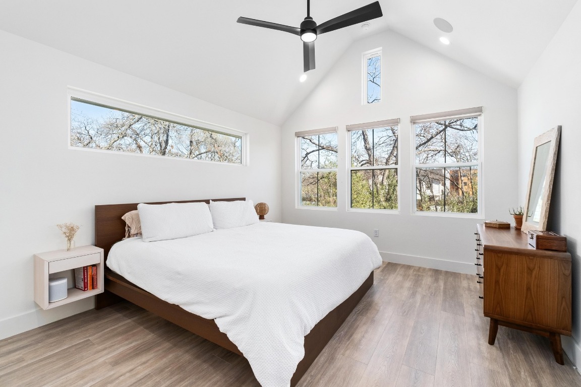 3302 Thompson Street, Unit 1 Austin, TX 78702 - Photo 19 of 32 a large bedroom with a bed and a flat tv screen on dresser