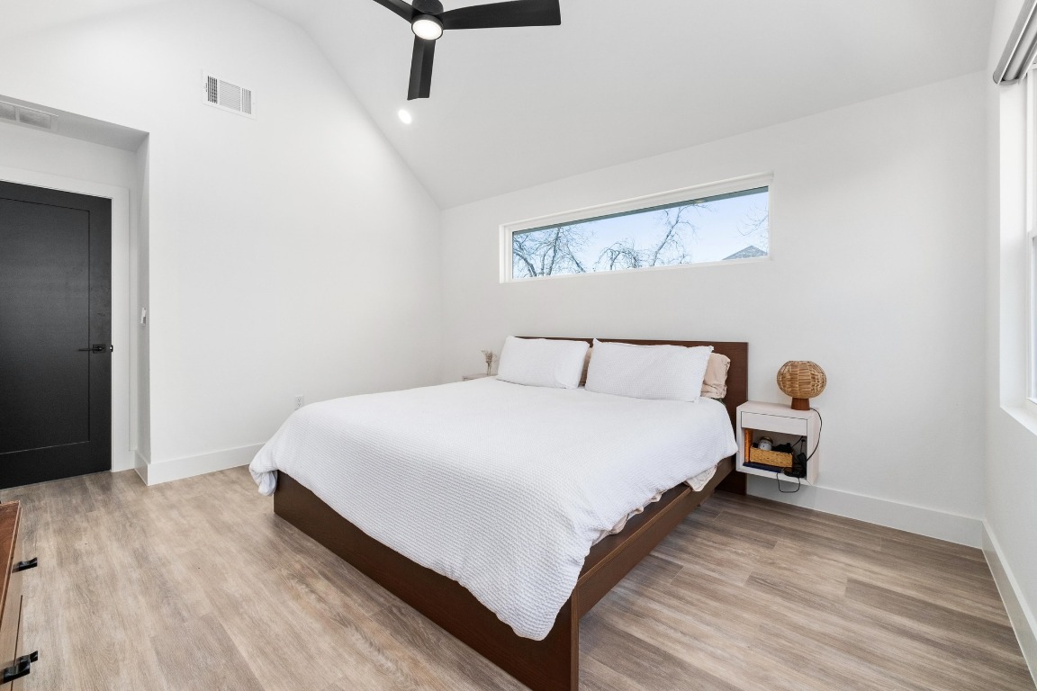 3302 Thompson Street, Unit 1 Austin, TX 78702 - Photo 20 of 32 a bedroom with a bed and wooden floor