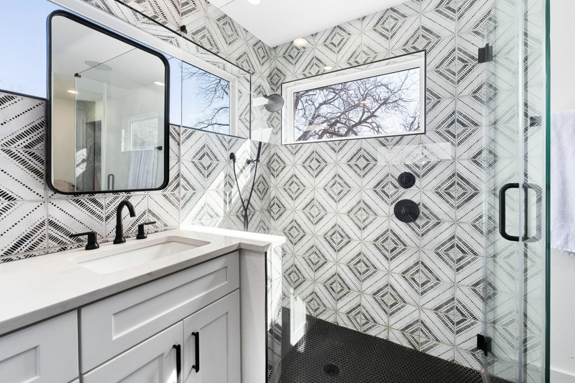3302 Thompson Street, Unit 1 Austin, TX 78702 - Photo 22 of 32 a bathroom with a sink vanity and a mirror