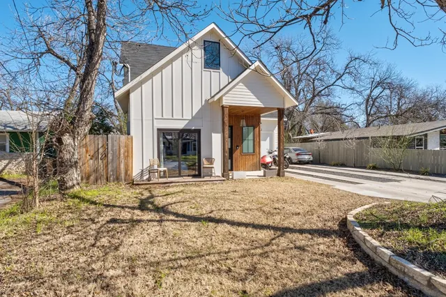 a living room with furniture a wooden floor and a kitchen view