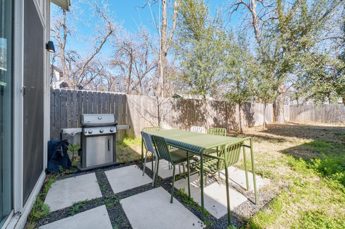 3302 Thompson Street, Unit 1 Austin, TX 78702 - Photo 32 of 32 a view of a patio with table and chairs potted plants and large tree