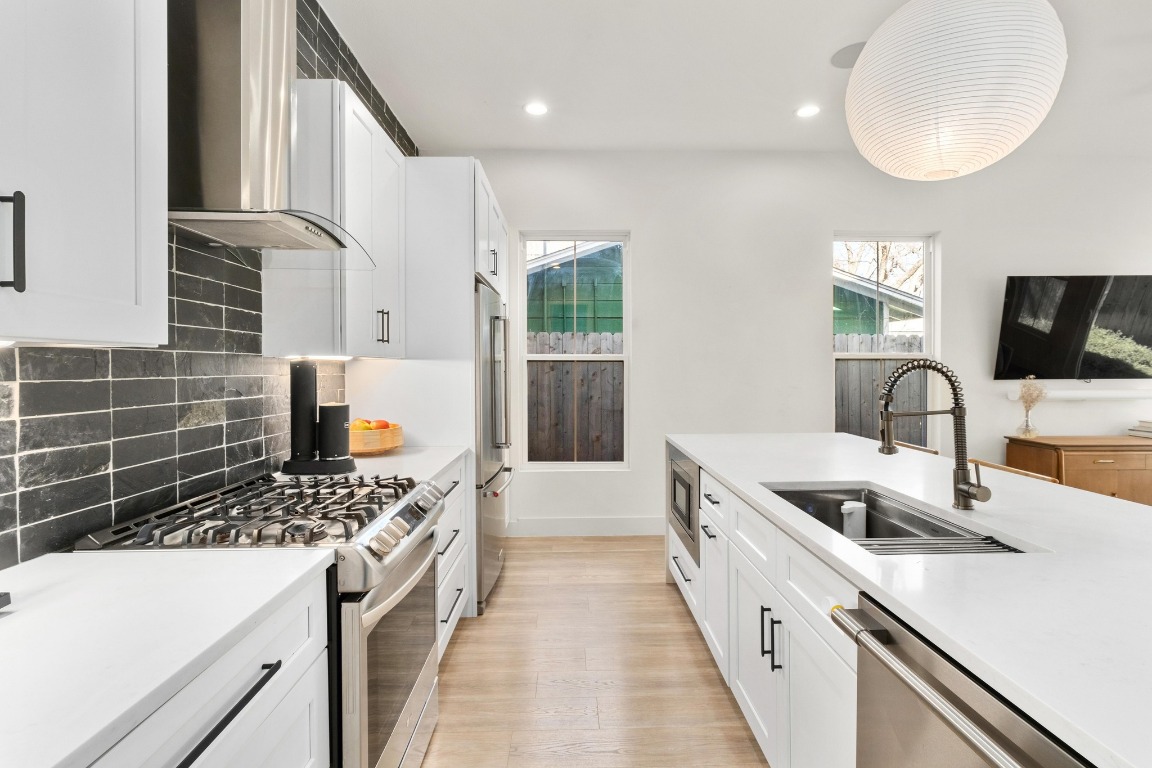 3302 Thompson Street, Unit 1 Austin, TX 78702 - Photo 9 of 32 a kitchen with sink a stove and a microwave