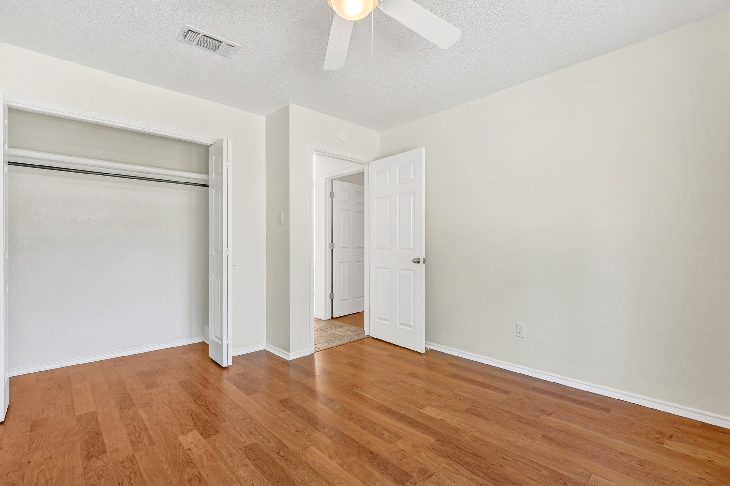 5221 84th Street Lubbock, TX 79424 - Photo 20 of 26 a view of an empty room with a chandelier fan