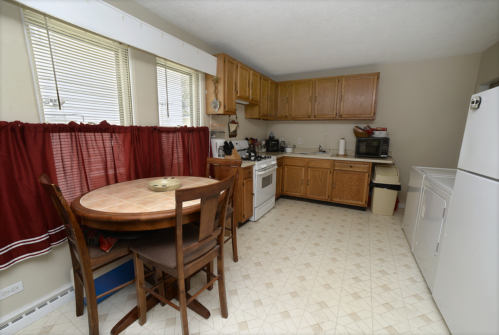 613 Webster Street Ottawa, IL 61350 - Photo 4 of 15 a large kitchen with a table and chairs in it