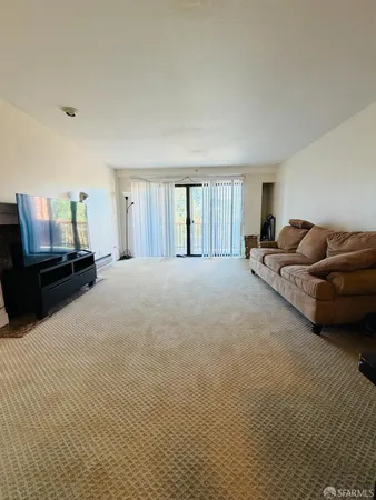 a large bedroom with a bed and a couch