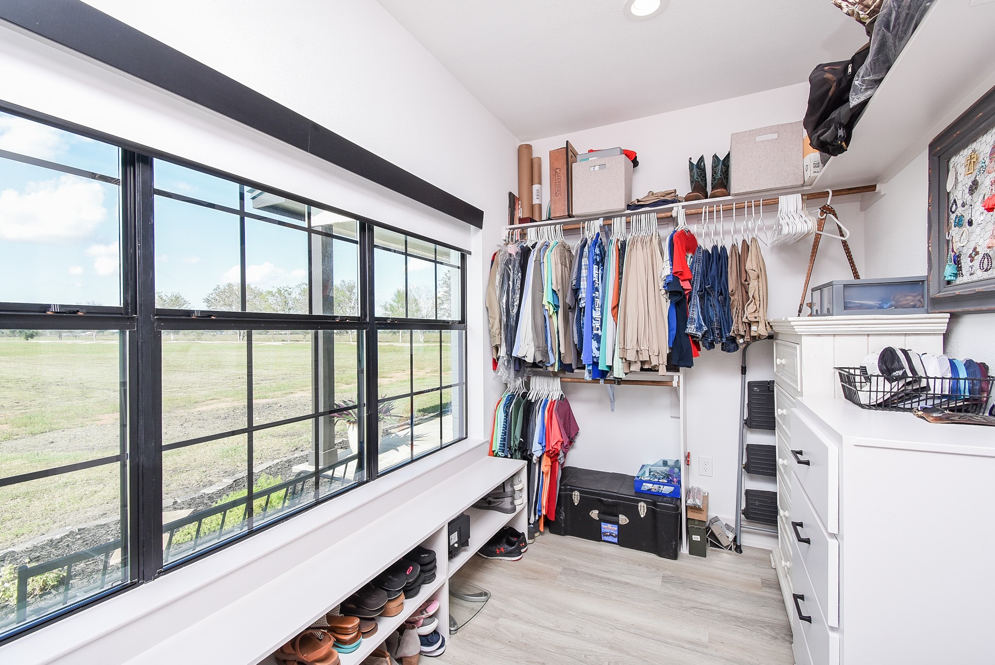 15007 Barak Road Guy, TX 77444 - Photo 21 of 34 a view of walk in closet with clothes and shoes