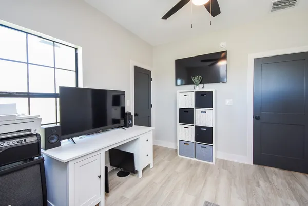 a view of living room with flat screen tv and window