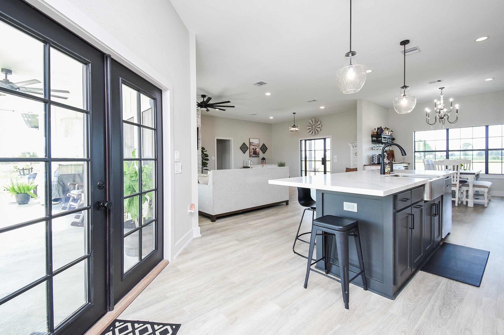 15007 Barak Road Guy, TX 77444 - Photo 7 of 34 a view of a dining room and livingroom with furniture wooden floor a chandelier
