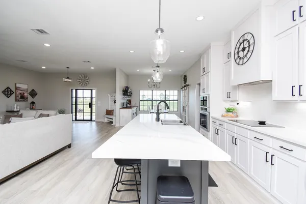 a large kitchen with kitchen island a table and chairs
