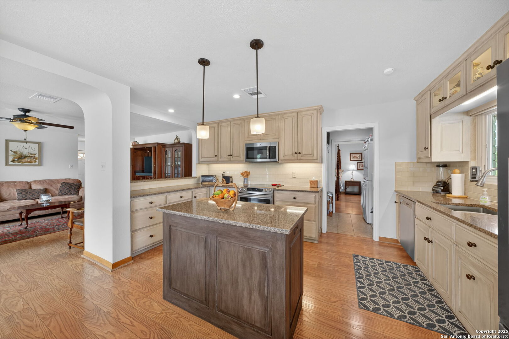 175 Forest Oaks Lane Lakehills, TX 78063 - Photo 11 of 36 a kitchen with stainless steel appliances kitchen island granite countertop a stove a sink a refrigerator and cabinets