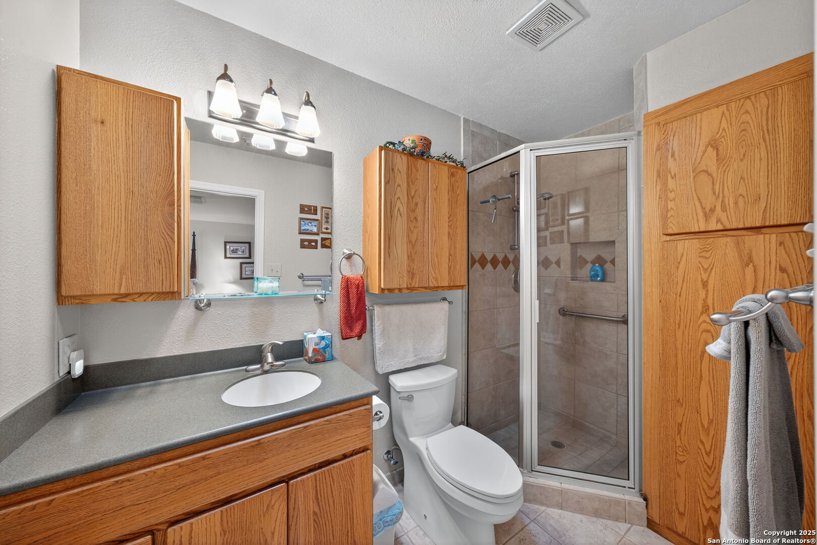 175 Forest Oaks Lane Lakehills, TX 78063 - Photo 24 of 36 a bathroom with a granite countertop sink toilet and shower