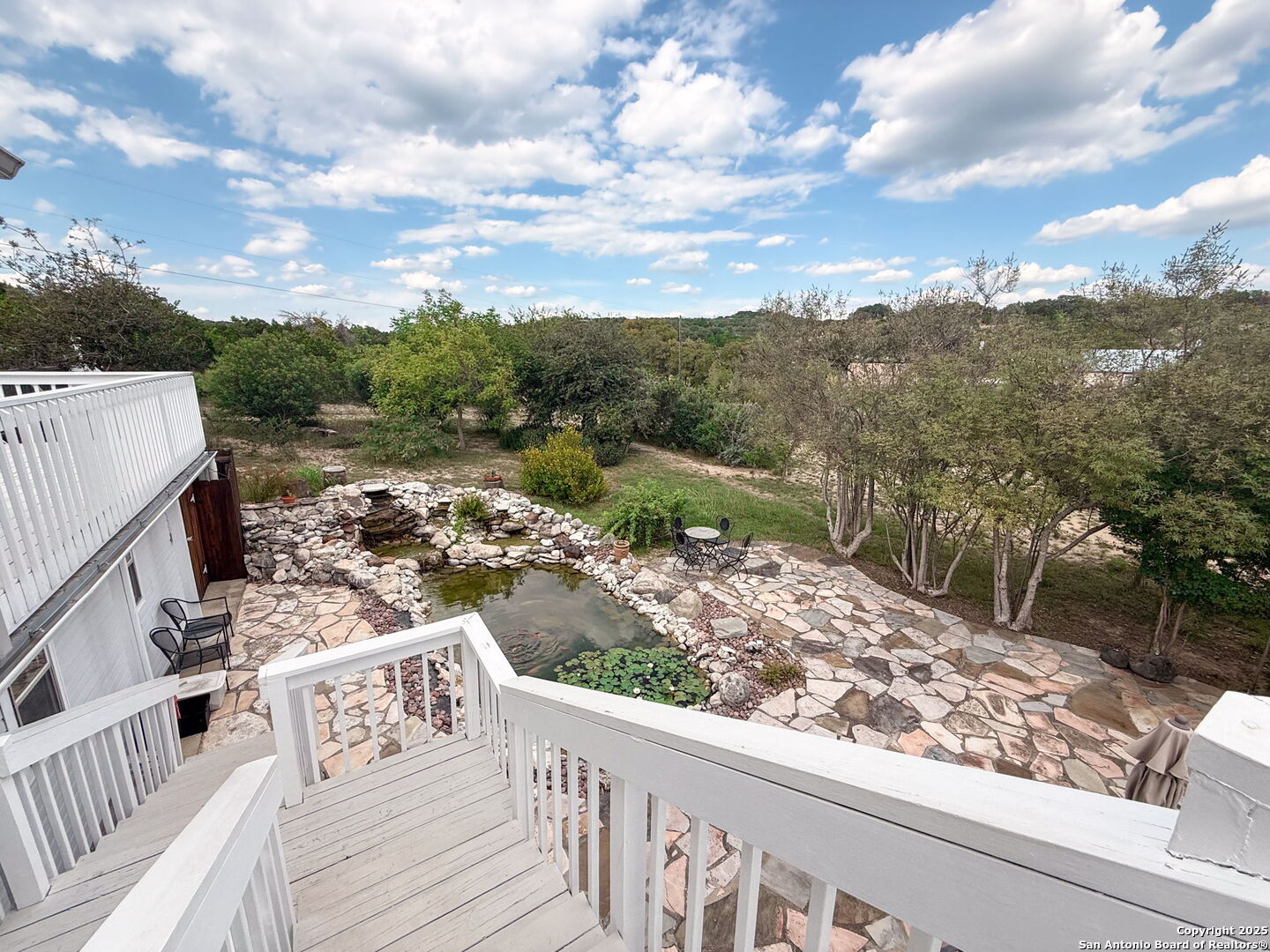 175 Forest Oaks Lane Lakehills, TX 78063 - Photo 28 of 36 a view of a balcony with wooden fence and floor