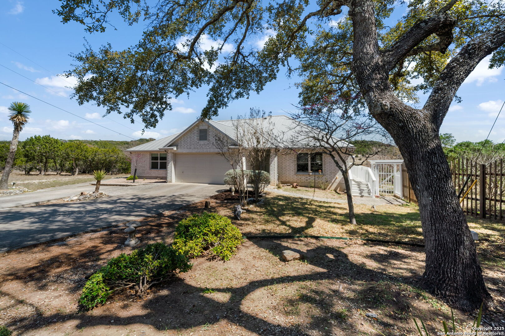 175 Forest Oaks Lane Lakehills, TX 78063 - Photo 3 of 36 a front view of a house with garden