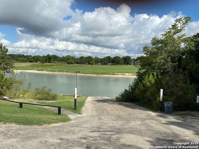 175 Forest Oaks Lane Lakehills, TX 78063 - Photo 36 of 36 a view of a lake with a garden