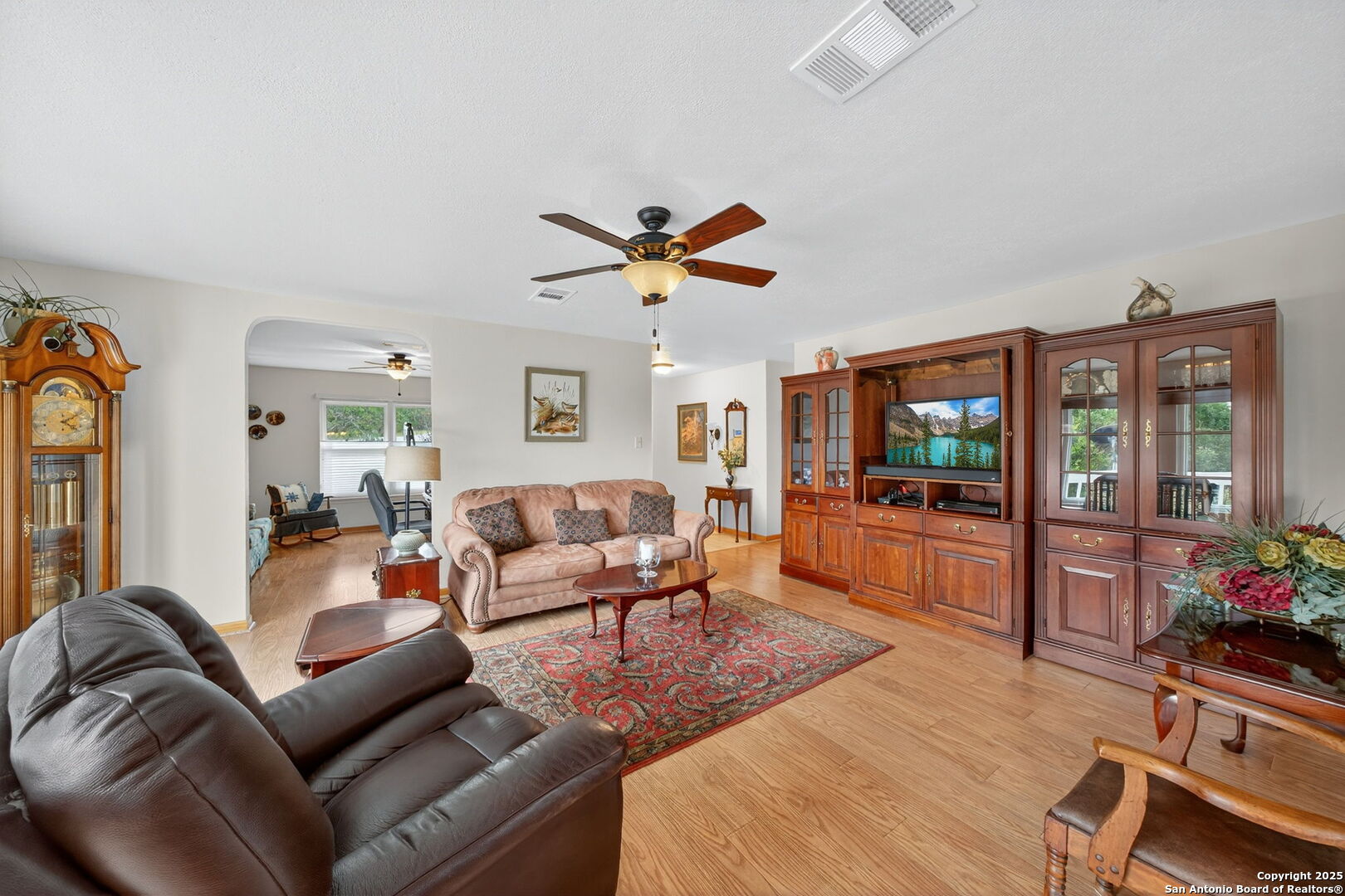 175 Forest Oaks Lane Lakehills, TX 78063 - Photo 6 of 36 a living room with furniture a fireplace and a flat screen tv