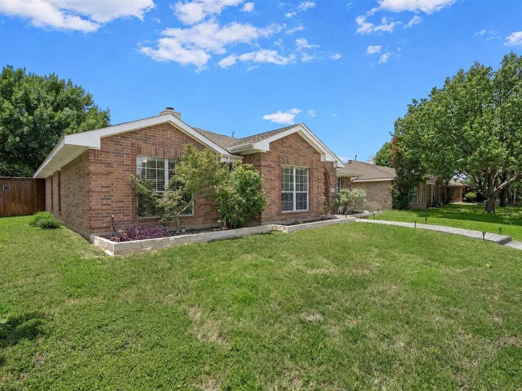204 Arbor Ridge Drive Allen, TX 75002 - Photo 2 of 36 Brick exterior residence with white trim, featuring a concrete walkway, established landscaping, and a fenced side yard