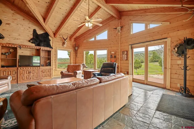 a living room with furniture and a floor to ceiling window