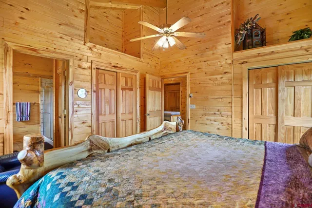 a bedroom with a bed and a large window