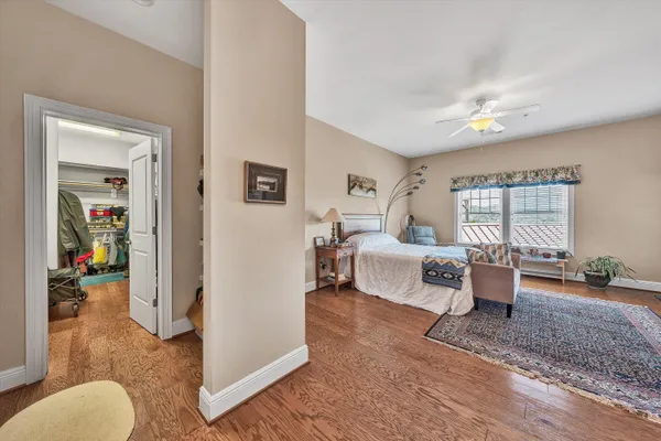 a bedroom with furniture and wooden floor
