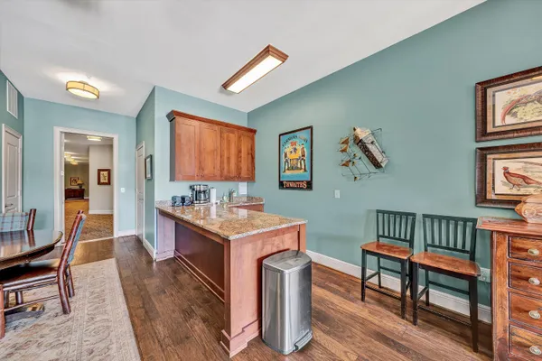 a dining room with furniture and wooden floor