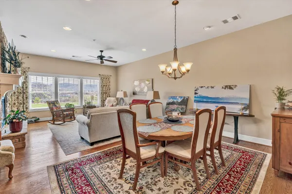 a dining room with furniture a rug and a chandelier