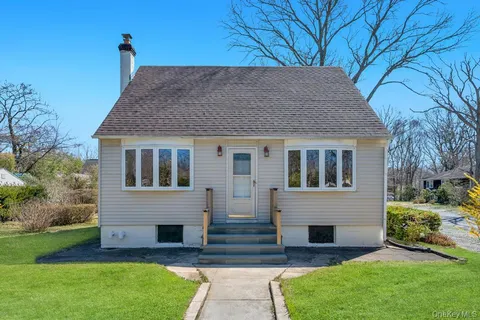 a front view of house with yard and green space