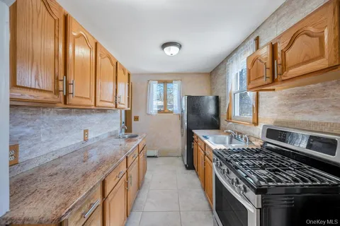 a kitchen with stainless steel appliances granite countertop a stove a sink and a refrigerator